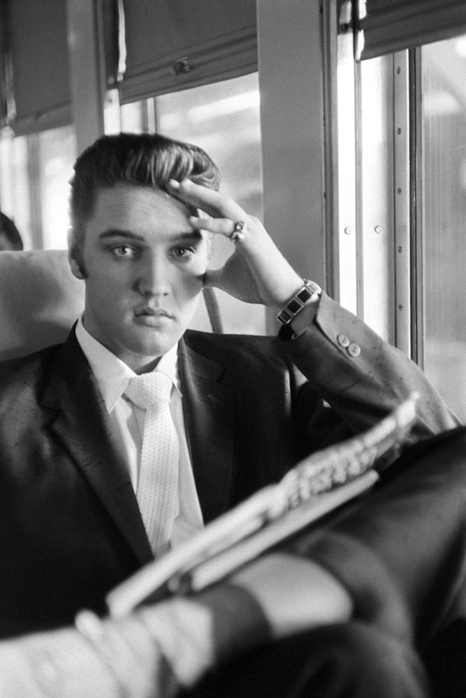 #17 Elvis reading an Archie comic book on a train journey, 1956.