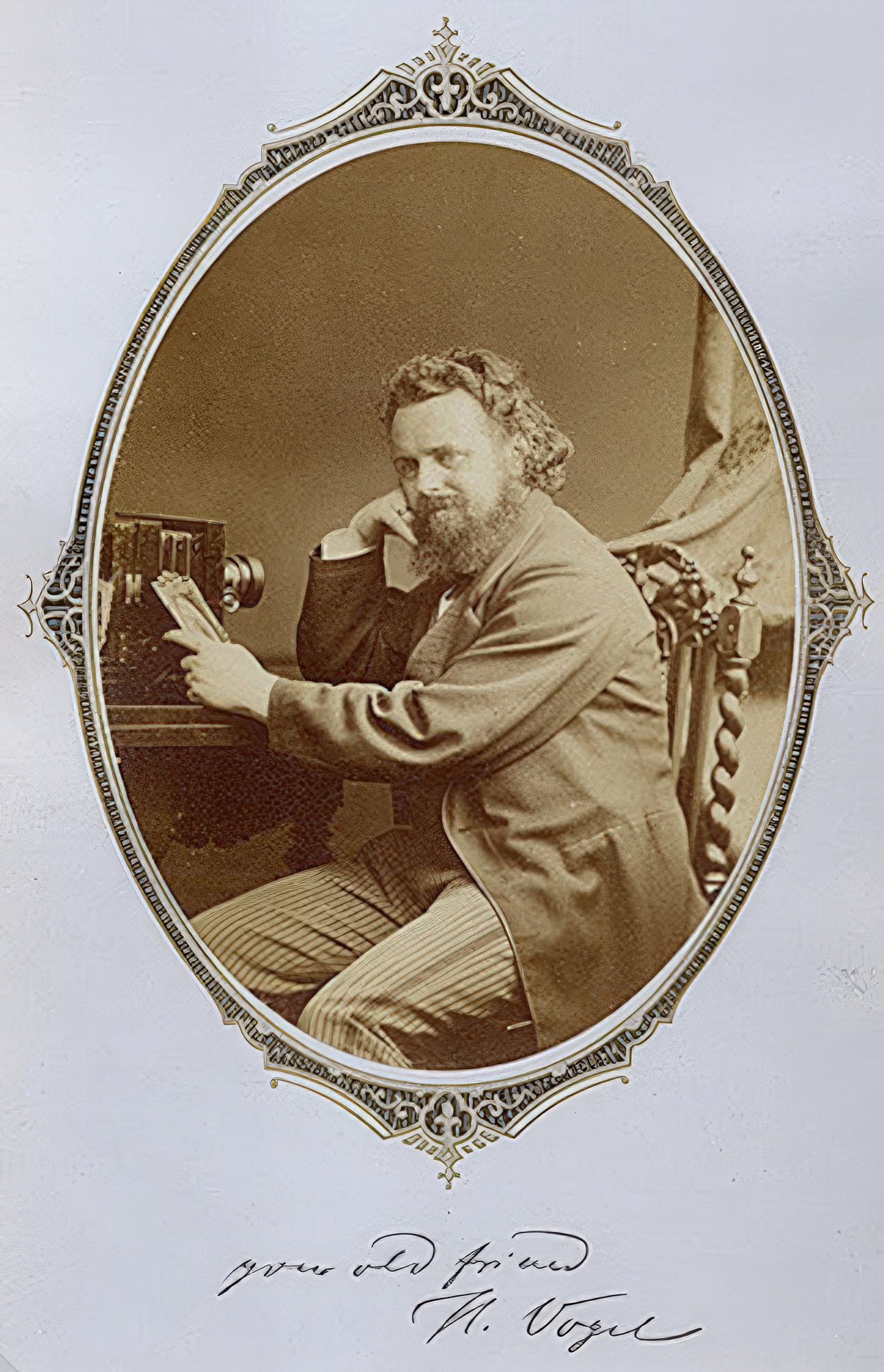 Dr. Hermann Wilhelm Vogel poses with his camera in an oval cut albumen print mounted on a gold and black decorative page. The handwritten text reads “your old friend H. Vogel” and we can not determine if it is written or printed on the mount. Vogel was a famous figure in 19th century photography and well known as the teacher of Alfred Steiglitz.