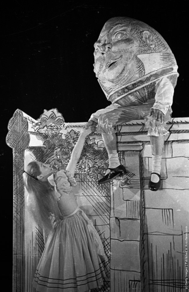 Roma Beaumont as Alice with Humpty Dumpty in a stage production of “Alice in Wonderland,” 1944