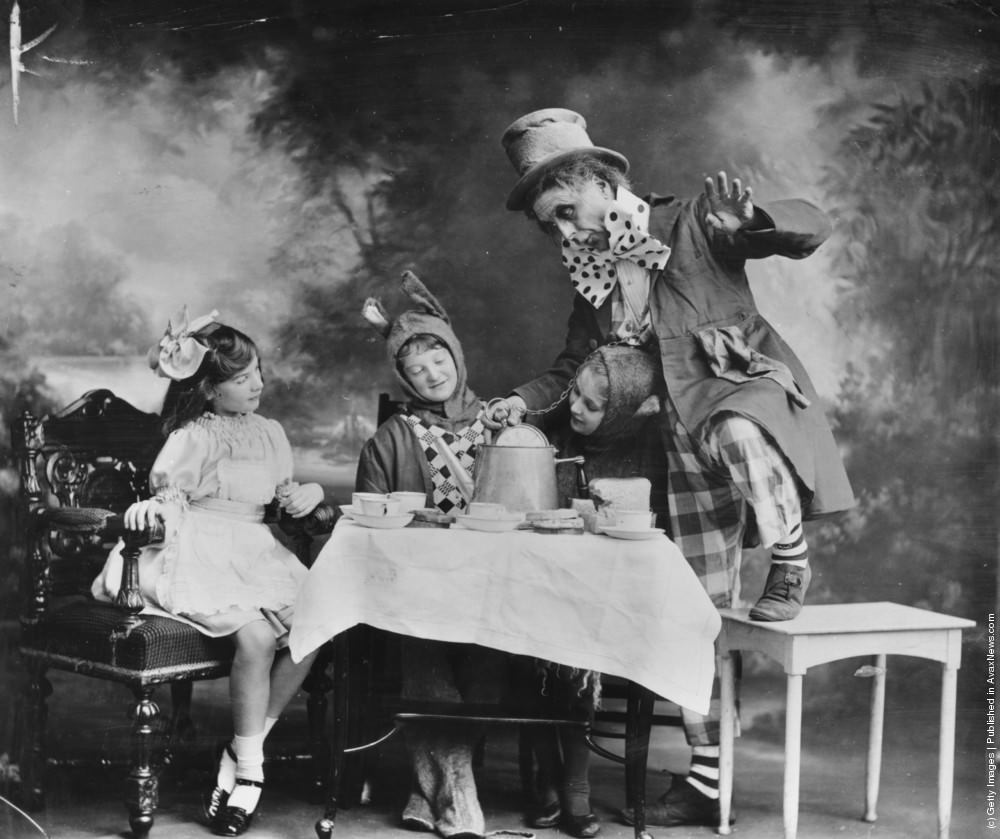 The Mad Hatter’s tea party from a theatre production of “Alice in Wonderland,” 1910