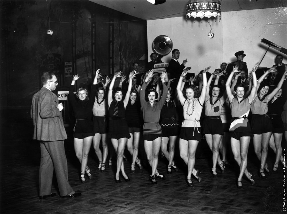 #29 Andre Charlot rehearsing his chorus for the Grand Ball at the Royal Opera House, London, 1929.