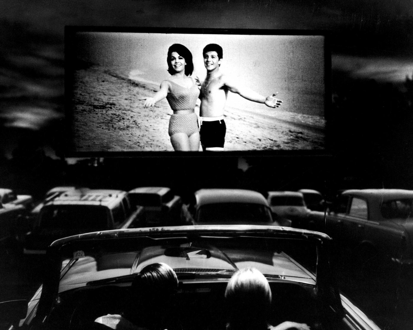 #1 Annette Funicello and Frankie Avalon in a scene from Beach Blanket Bingo, shown at a drive-in movie theater in Florida, 1965