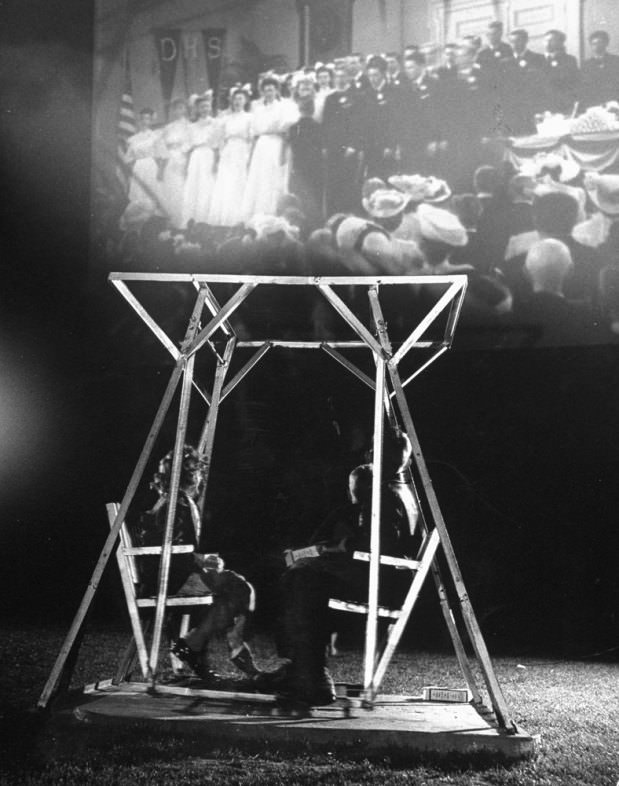 #19 Kids enjoy one of the four double-seated glider swings in the mini-playground at the Rancho Drive-In Theater, San Francisco, 1948