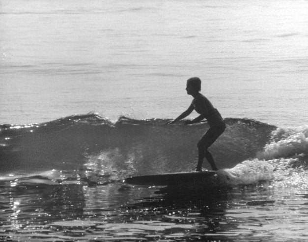 #15 Sixteen-year-old Kathy Kohner (the real-life inspiration for the character of Gidget) rides a wave, Malibu, Calif., 1957