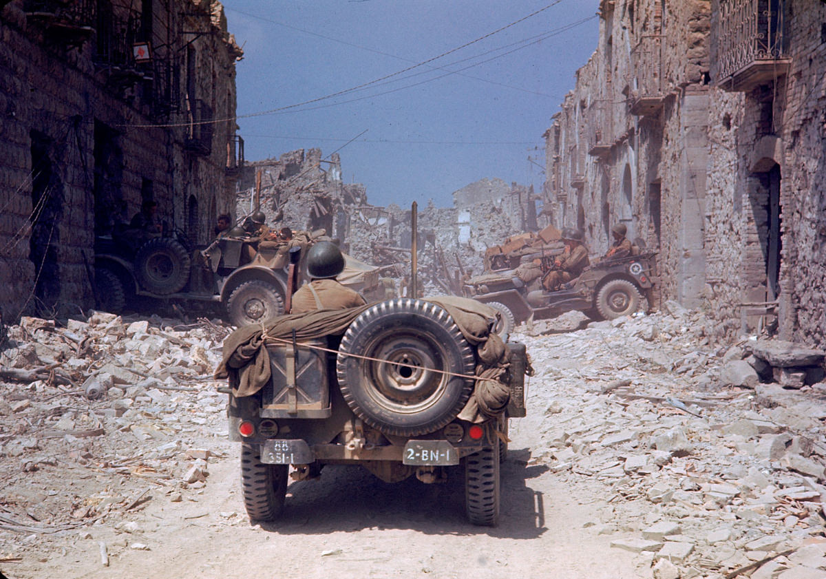 #2 American jeeps traveled through a bombed-out town during the drive towards Rome, World War II, 1940s.