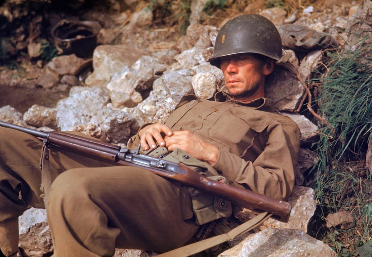 #15 An American soldier sleeping on rocks during the drive towards Rome, 1944.