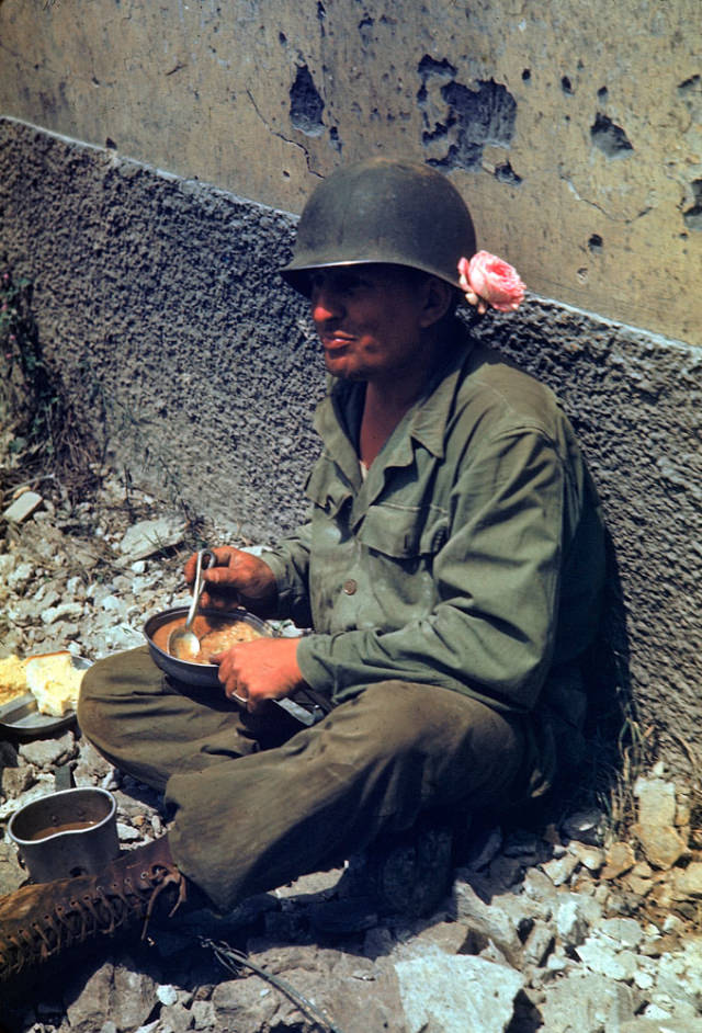 #19 An American soldier taking a meal break during the drive towards Rome, 1944.