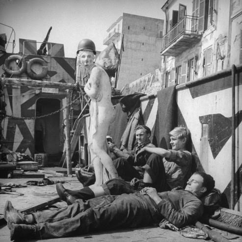 #27 American soldiers with their mascot, “Axis Sally,” at Anzio, 1944.