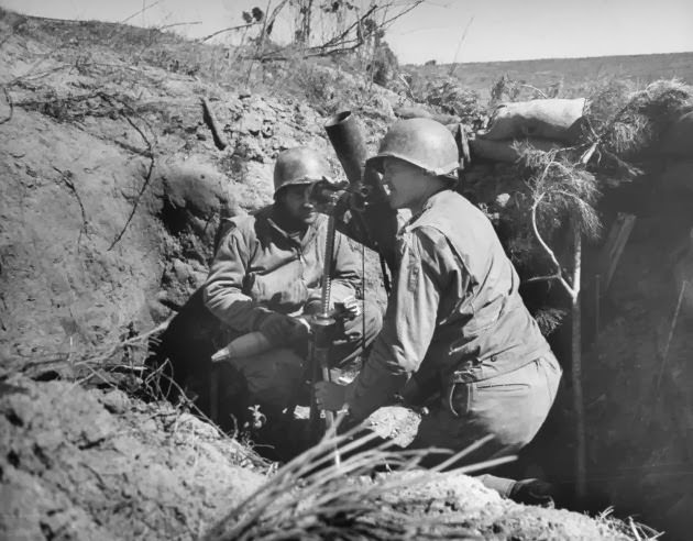 #36 American soldiers sighting a mortar from a dugout at Anzio, 1944.