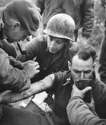 A wounded American soldier awaiting an ambulance at Anzio, 1944.