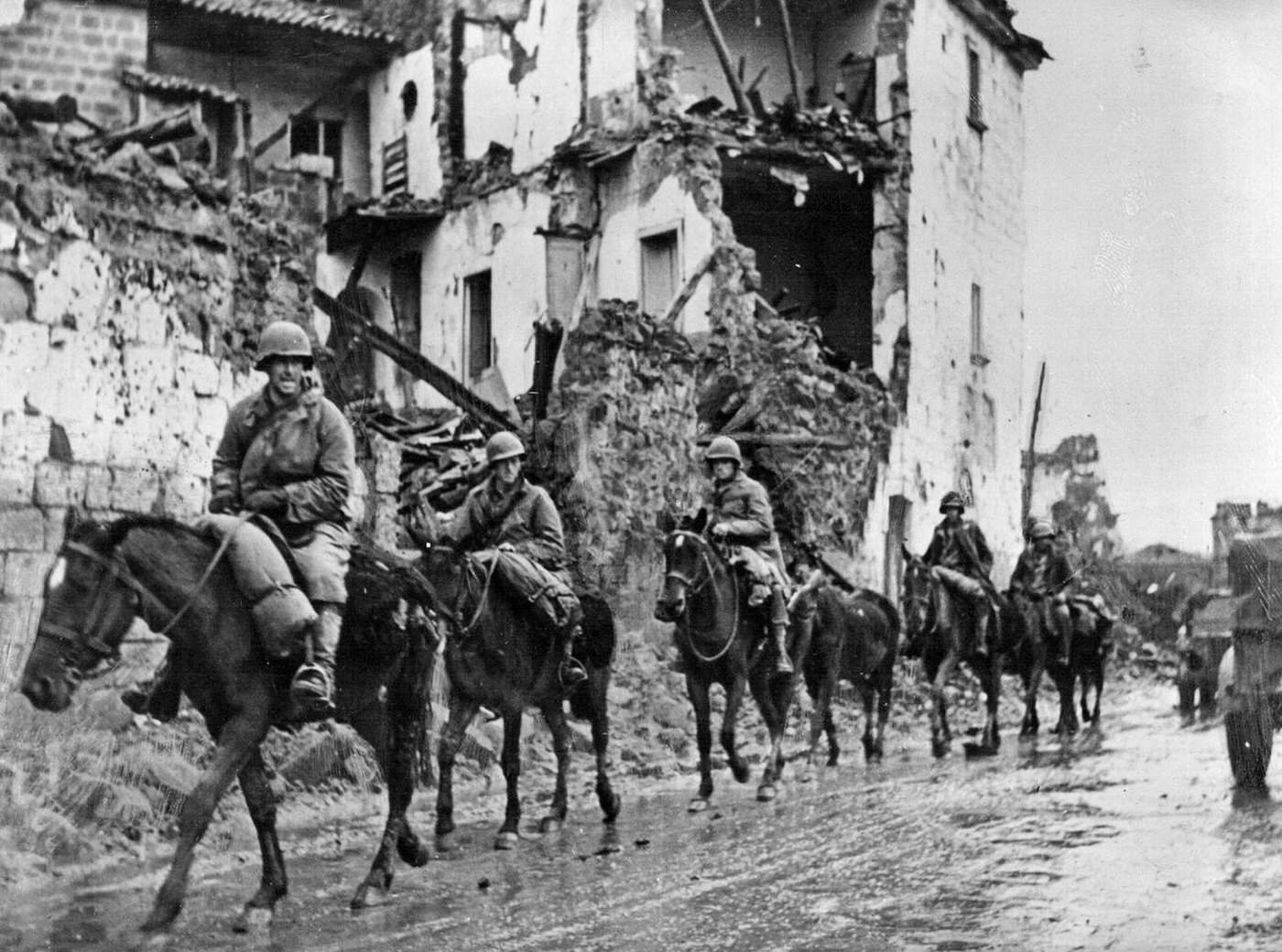 #57 A U.S. cavalry detachment passing through an Italian town, 1943.