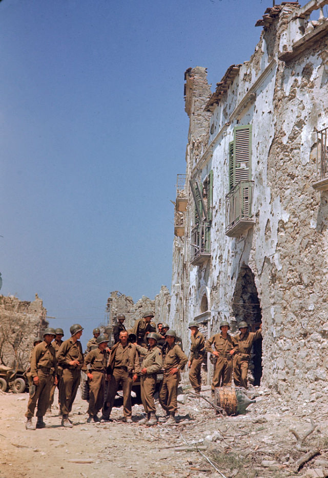 #7 American troops stood in front of a bombed-out building during the drive towards Rome, World War II, 1940s.