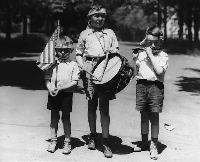 #7 Three boys dressed as a patriotic band to celebrate Independence Day on July 4th, circa 1940.