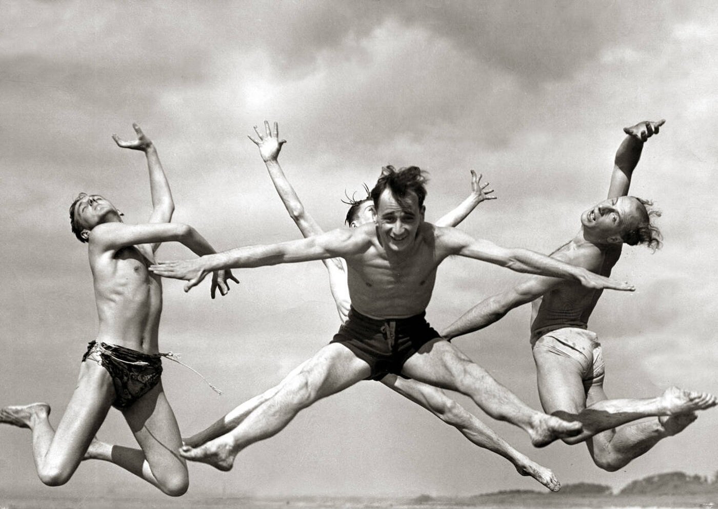 #28 Men joyfully dancing on the beach during their holidays, 1950.