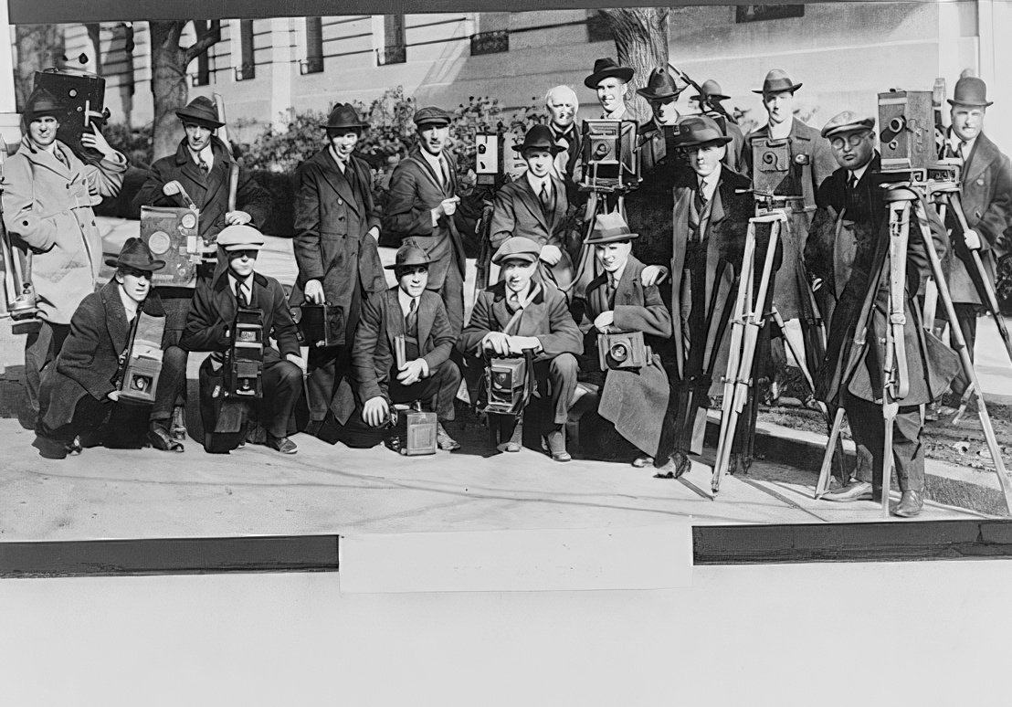 Group portrait of seventeen members of the White House News Photographers’ Association, standing and squatting, facing front, with cameras, circa 1920s.