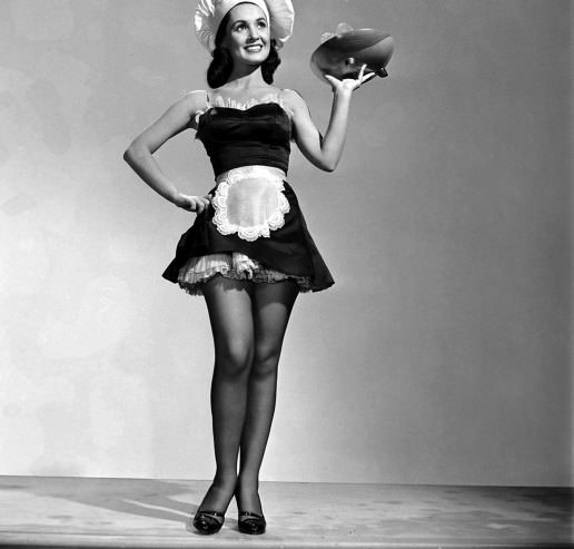 Susan Cabot, holding a salad bowl aloft, 1950