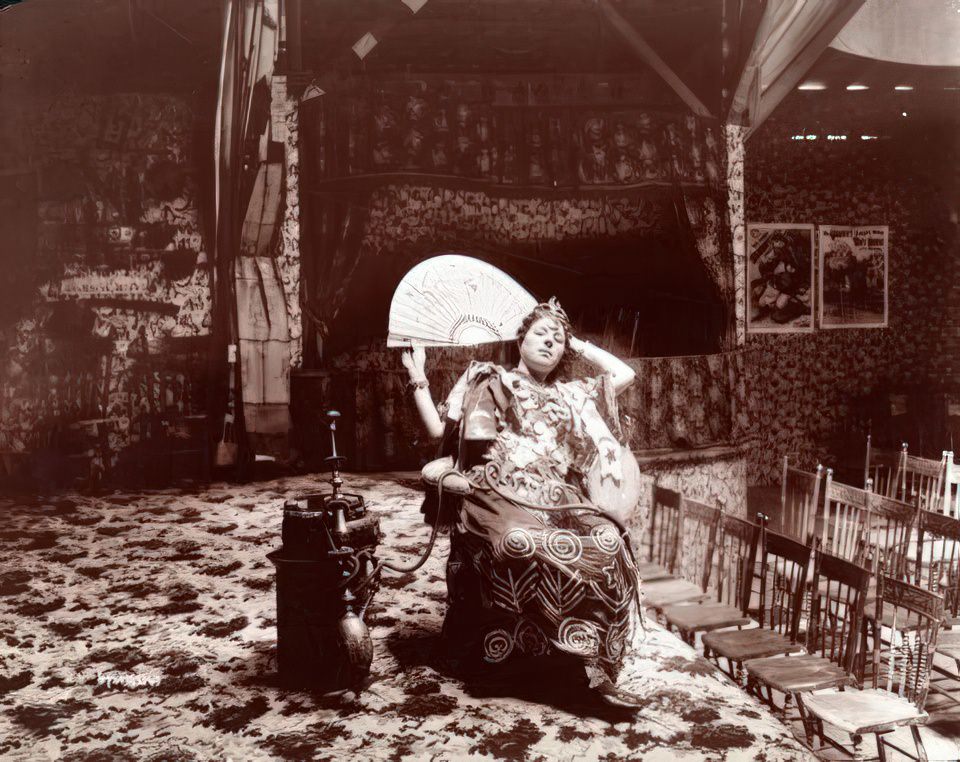 #9 Woman gypsy/dancer seated in her side-show theatre at Coney Island, ca 1896.