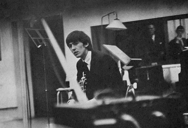George Harrison practicing music.