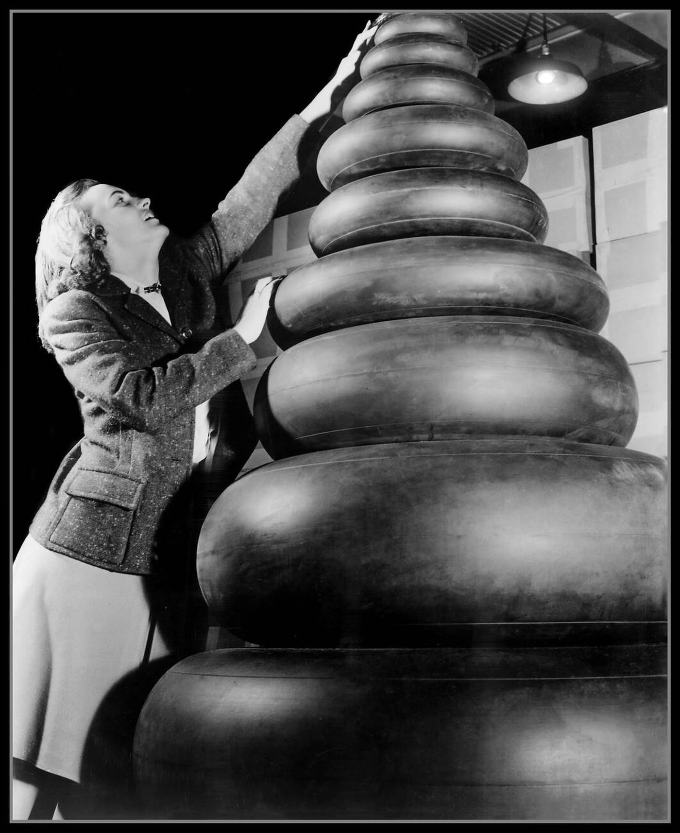 #67 A woman checking aircraft tires, 1940s