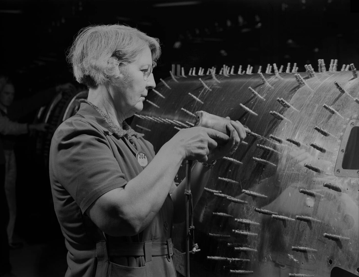 #98 A female worker drilling holes in a B-17, 1942