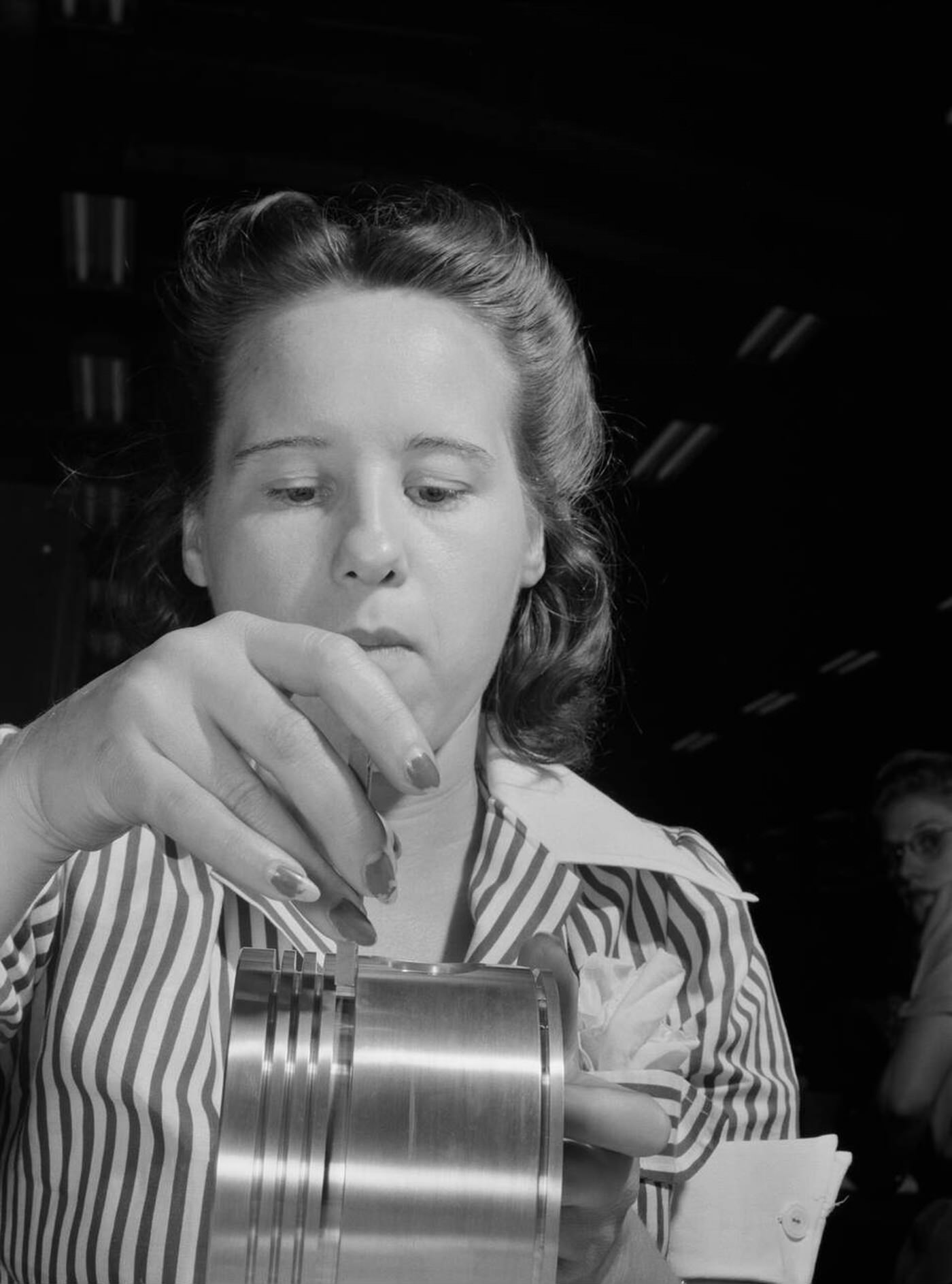 #99 Anne Weinman inspecting pistons, 1942