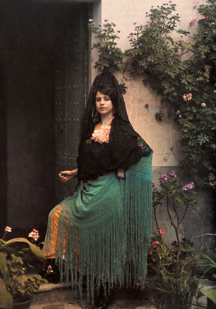 #19 A woman dressed for a bullfight stands in a doorway, August 1924.