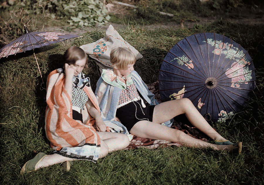 #24 Two young girls enjoy the sun relaxing in their suits and wraps in England, September 1929.