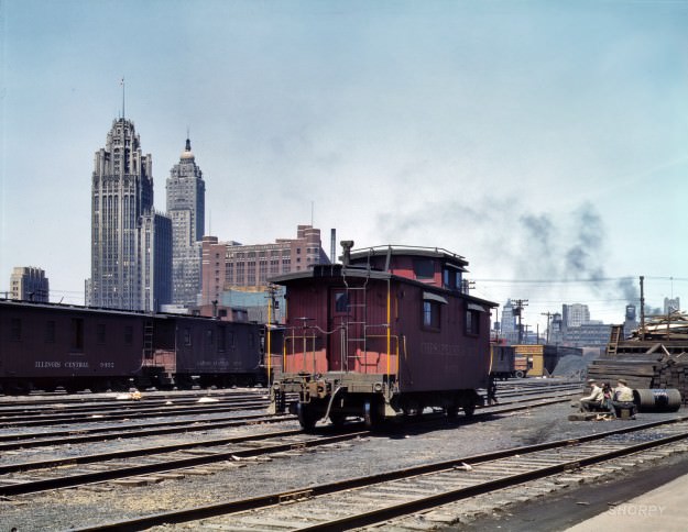 Chicago, April 1943. “General view of part of the South Water street freight depot of the Illinois Central Railroad. Chesapeake &; Ohio R.R. caboose.” 4×5 Kodachrome transparency by Jack Delano for the OWI.