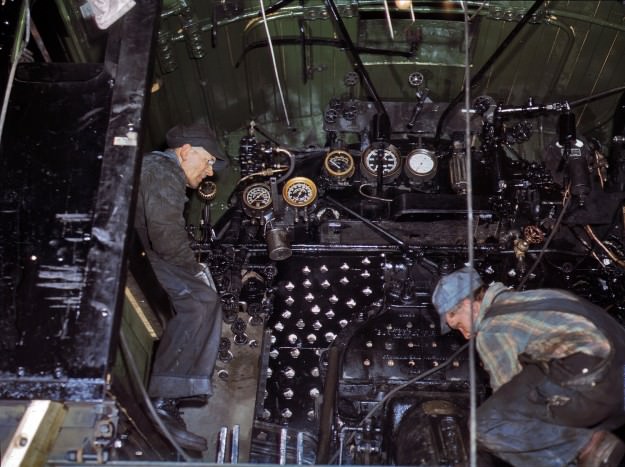 Working on the cab of a locomotive brought in for repairs at the Chicago &; North Western 40th Street shops, Chicago. December 1942. 4×5 Kodachrome transparency by Jack Delano.