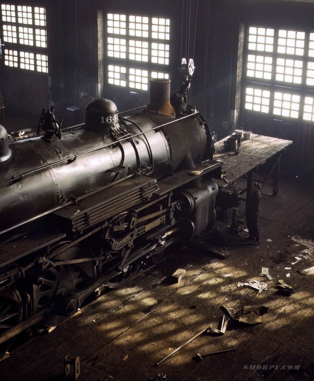 40th Street Shop, Chicago &; Northwestern R.R. December 1942. 4×5 Kodachrome transparency by Jack Delano. Back to the days of the blacksmith: The only tools seen here are two hammers, a wrench and a broom.