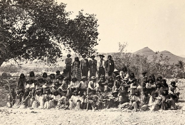 #18 Native American (Paiute) men, women and children posing under a tree near Cottonwood Springs (Washoe County), Nevada. Taken in 1875.