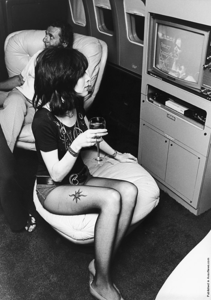 A young woman watching a video on board Led Zeppelin’s Boeing 720B “The Starship”, 1973.
