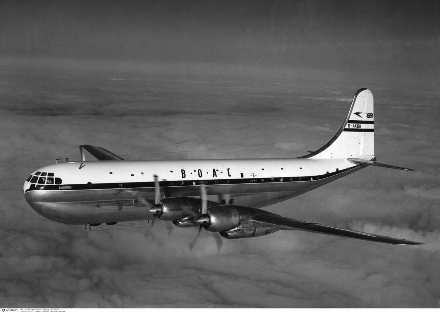A BOAC Boeing 377 “Stratocruiser” flying over clouds, 1940s.