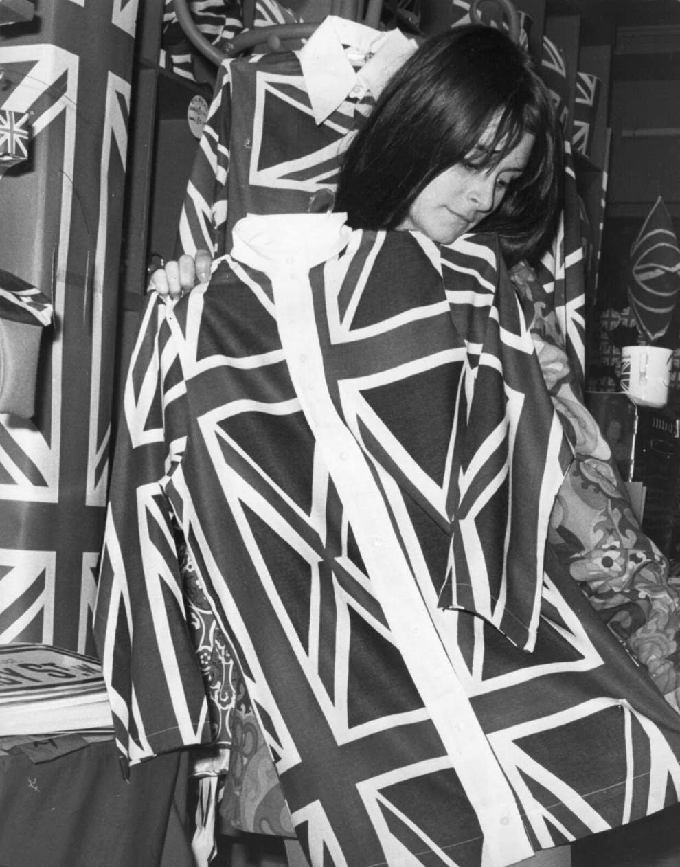 #13 7 January 1968: A boutique owner holds up Union Jack shirts.