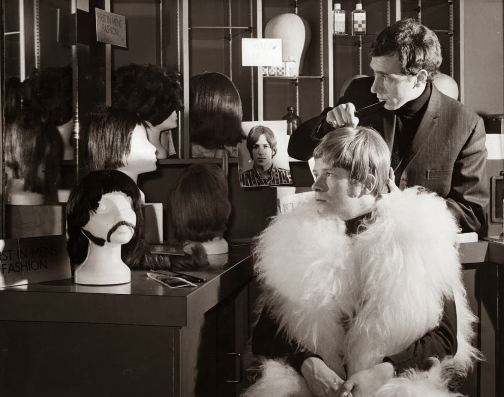 #5 circa 1968: Pop singer Long John Baldry being fitted with a wig at the John Stephen wig centre.