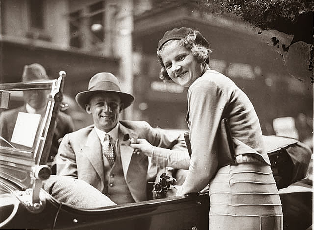 Poppy seller pins the flower on cricketer Don Bradman’s lapel outside the State Theatre, Sydney, 1930s.