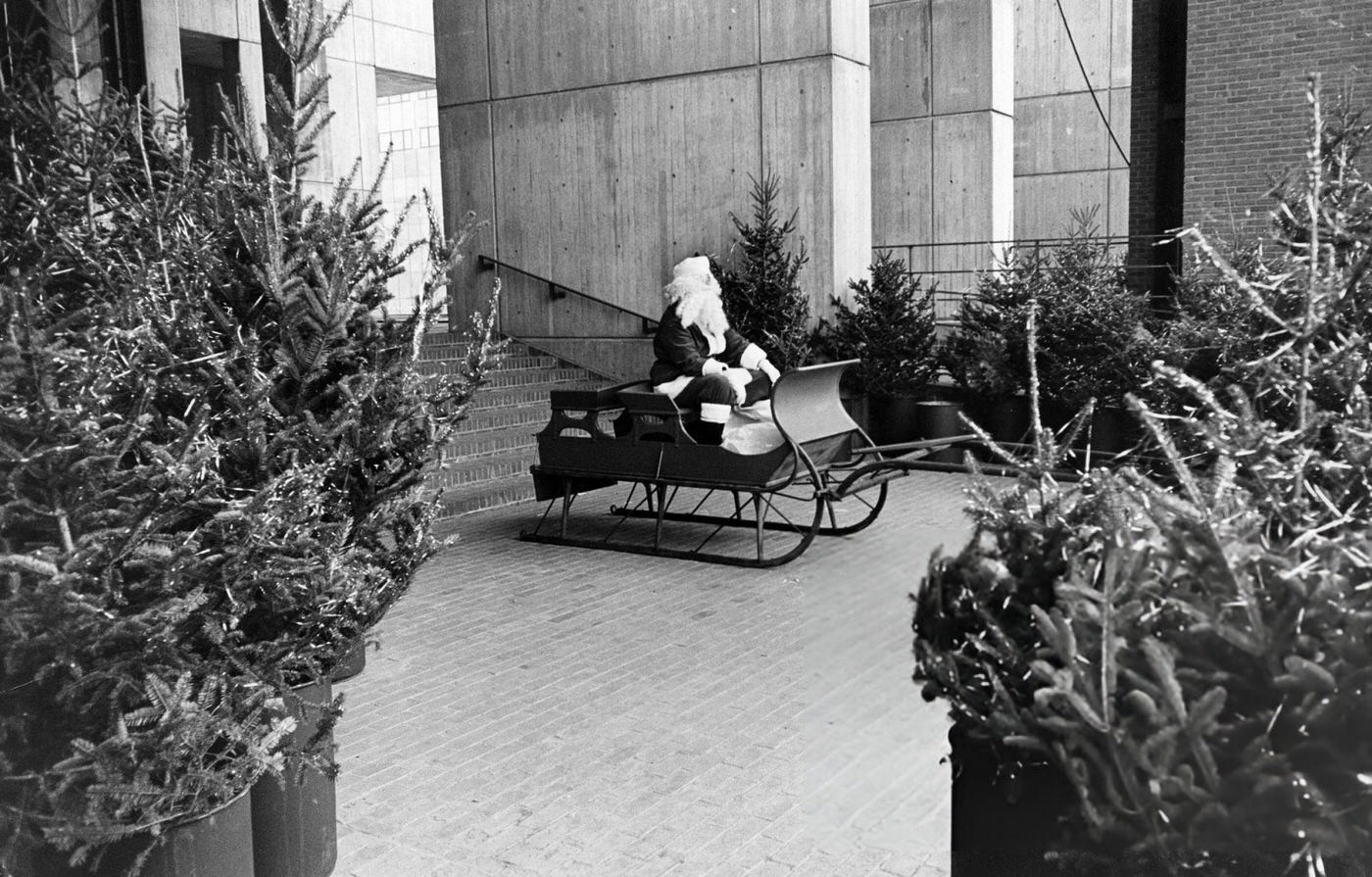 #40 A Santa Claus sits in a sled in City Hall Plaza in Boston, 1969.