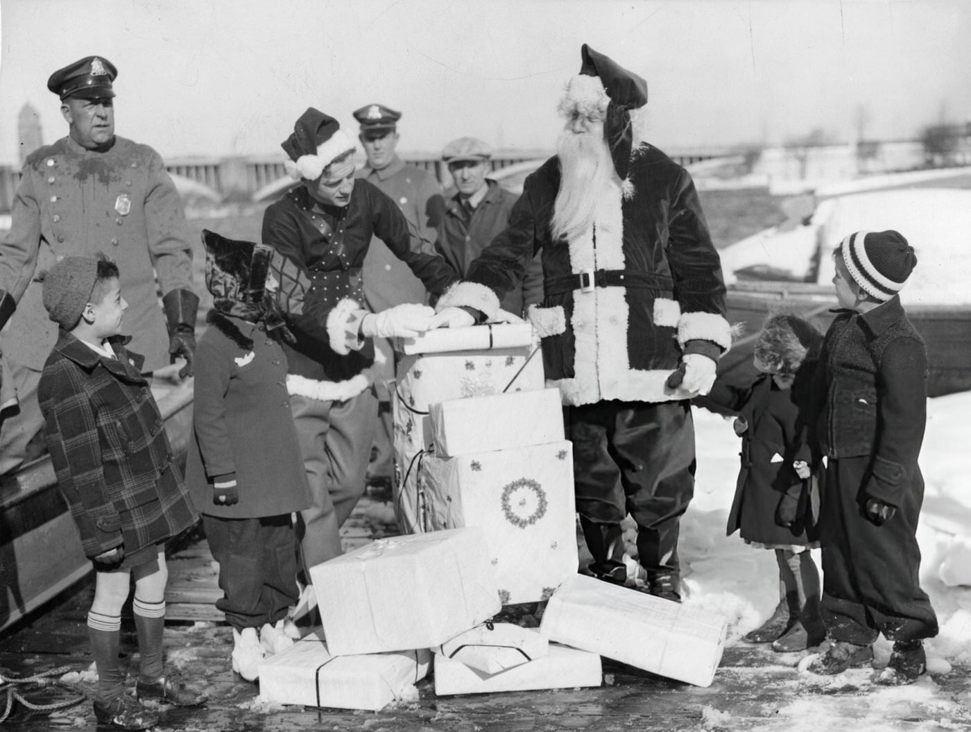 #15 Santa Claus and Santason hand out presents as part of the annual Santason parade in Boston, 1940.