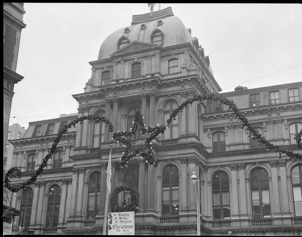 #9 The sign on another entrance to Boston City Hall called for “A Happy, A Holy, A Joyous Christmas To All,” 1954.