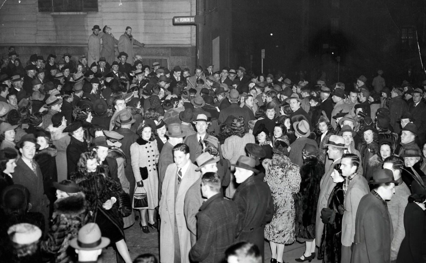 #16 Crowds on the corner of Mt. Vernon Street in Boston’s Beacon Hill on Christmas Eve, 1940.