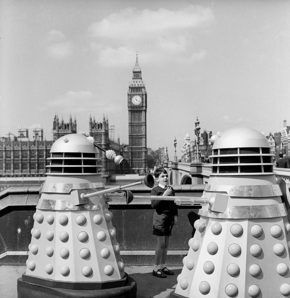 Andrew Tuttner meets two Daleks on Westminster Bridge, London for the new BBC series of ‘Dr Who’, 1964.