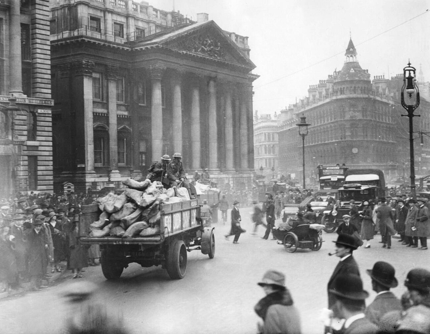 #100 A guarded truck transports food in London at the height of the Mansion House.