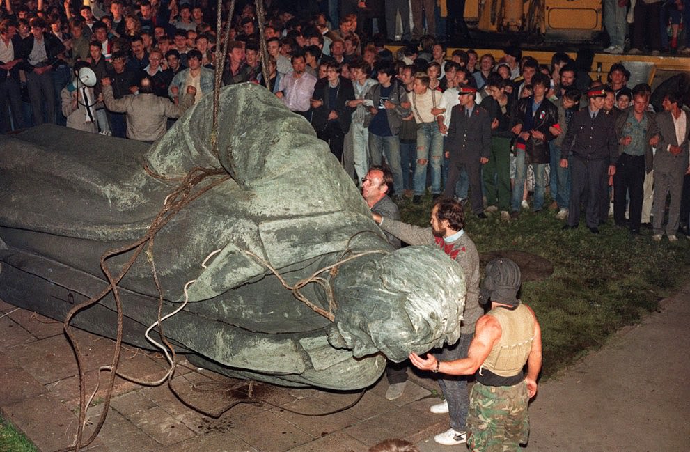 #33 A crowd watches the statue of KGB founder Dzerzhinsky being toppled in Lubyanskaya Square in Moscow, 1991.