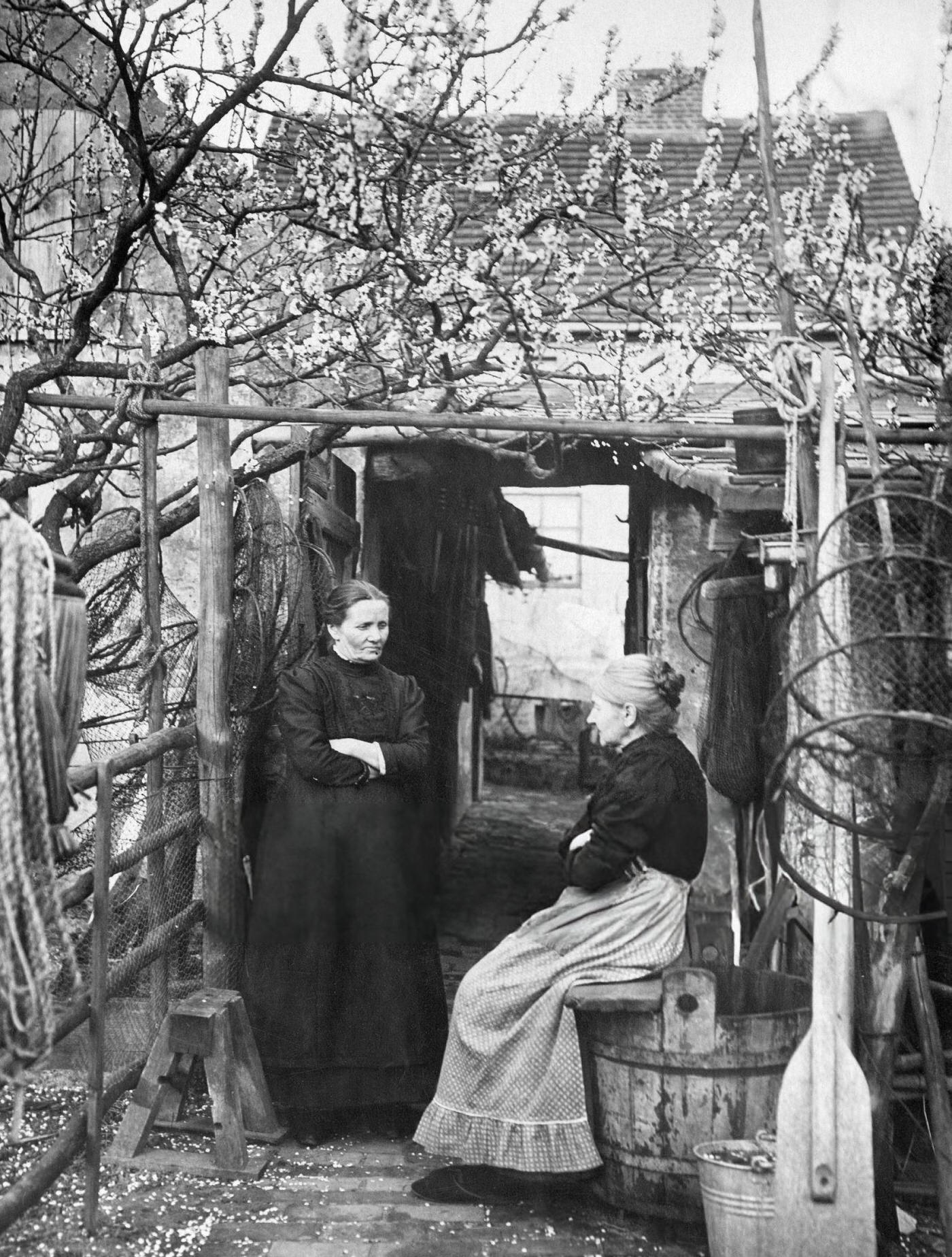 #35 Two women in the backyard of a homestead, Bavaria, possibly fisherwomen, 1910.
