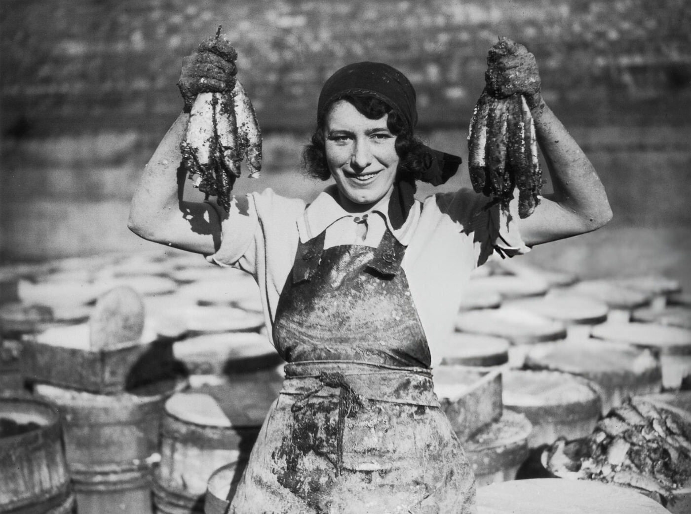 #43 A young woman at Great Yarmouth working during the herring harvest, 1932.