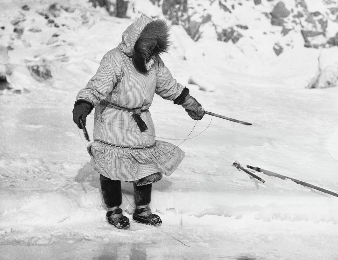 #45 Inuit woman fishes with a simple hook.