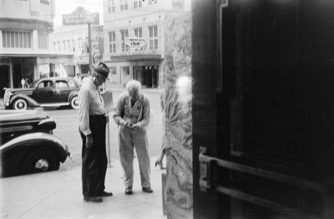 #78 Two elderly men talking on a sidewalk in downtown Fort Worth, Texas, 1937.