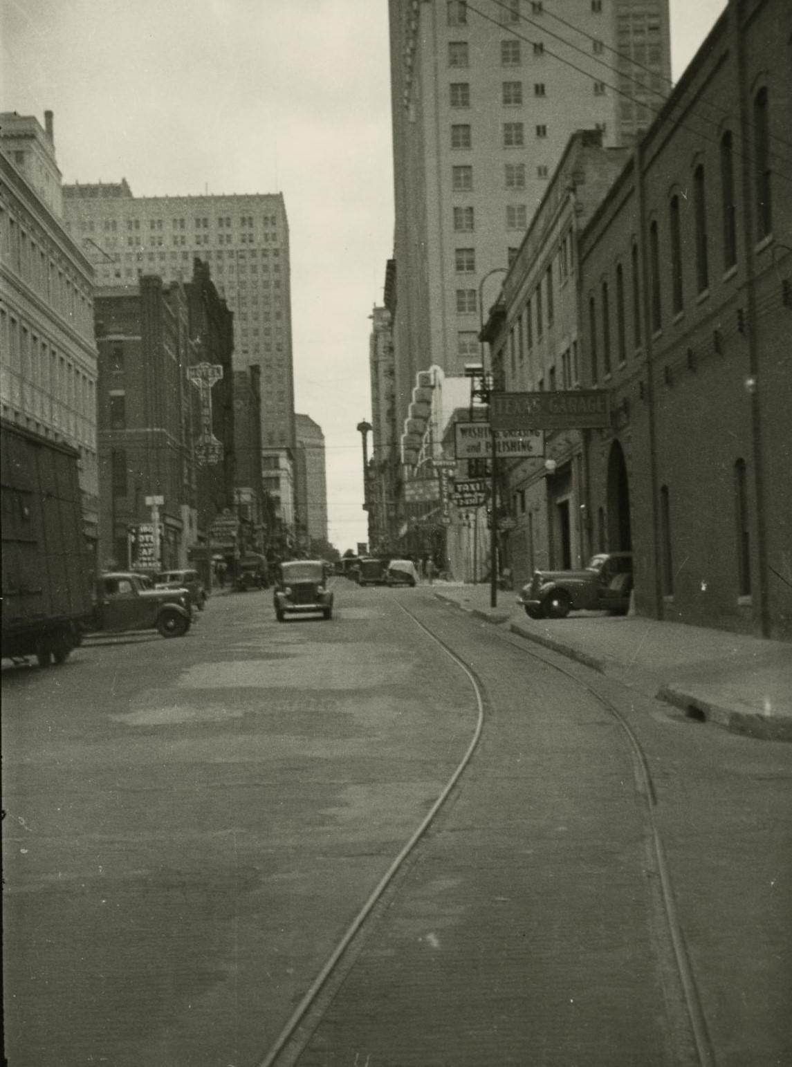 #83 A street overlooking downtown Fort Worth with trolley tracks, 1930s.