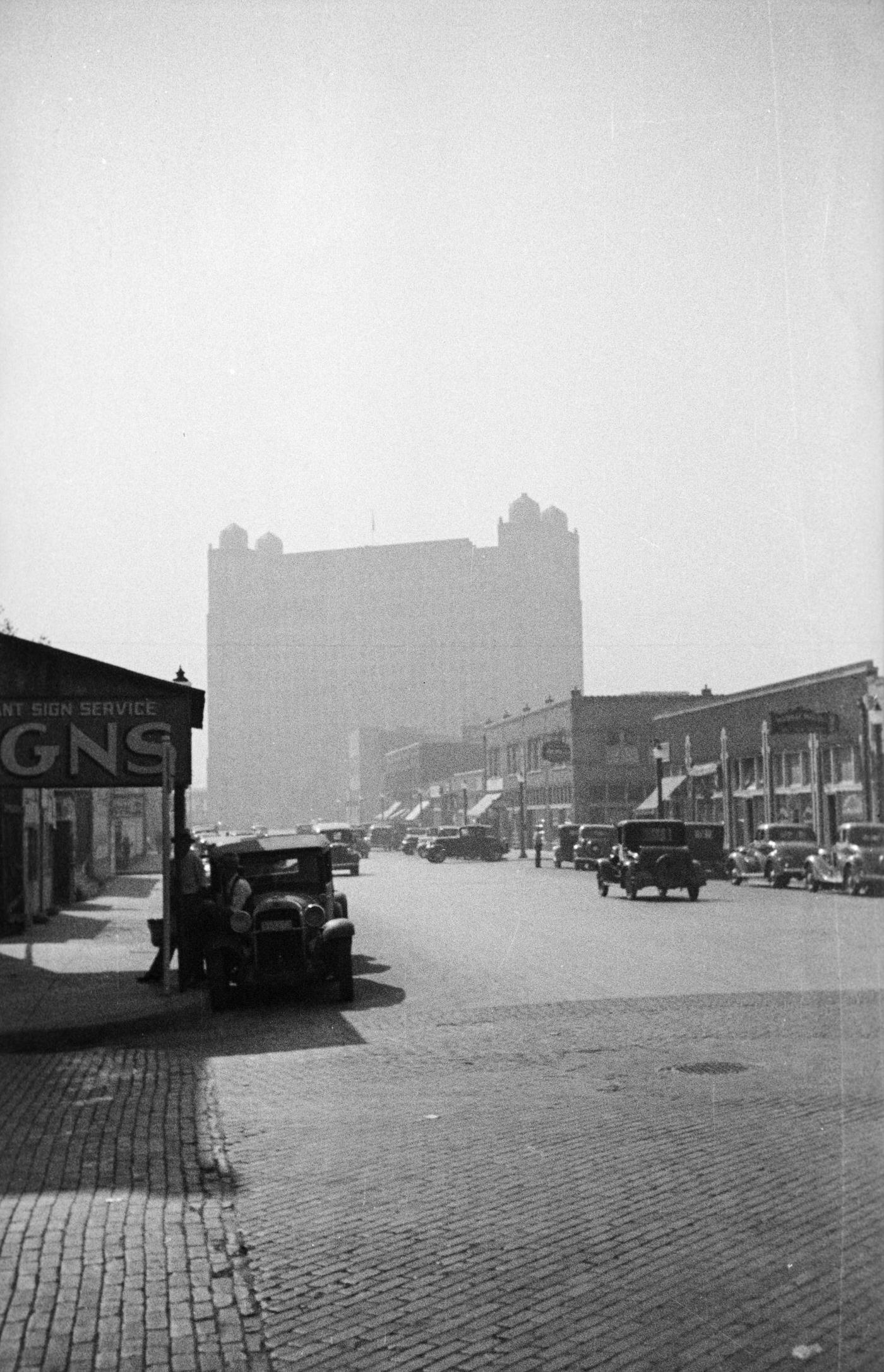 #84 A busy street lined with businesses in Fort Worth, Texas, 1930s.