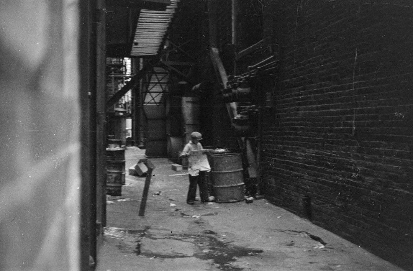 #88 A boy in an alleyway in downtown Fort Worth, Texas, 1937.
